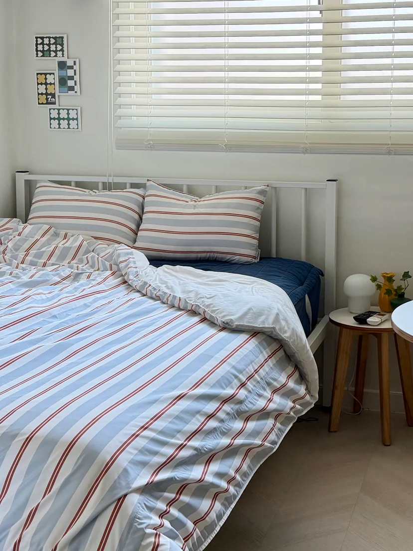 Double bed with striped bedding by the window (Listing ID : 35470)