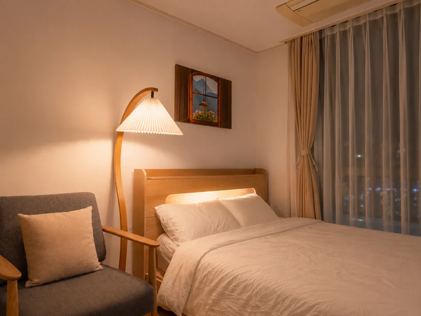 Warm floor lamp and a made bed at night (Listing ID : 47791)