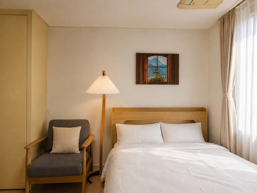 Bed, armchair and floor lamp beside a curtained window (Listing ID : 47791)