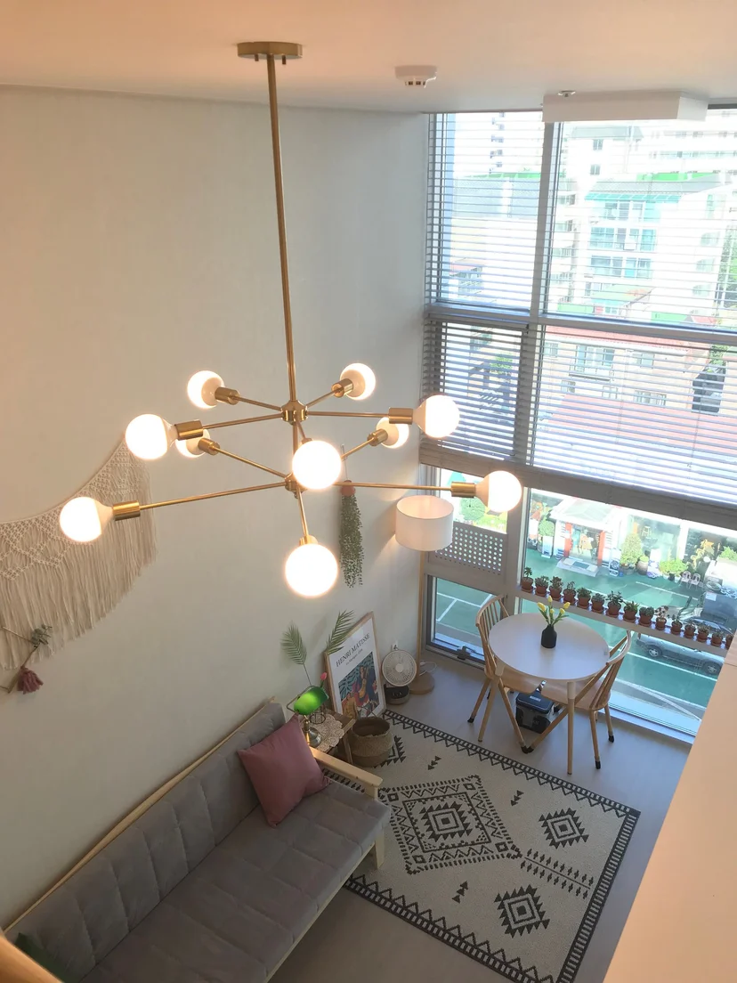 Loft living room with a sculptural chandelier and floor-to-ceiling windows (Listing ID : 31163)