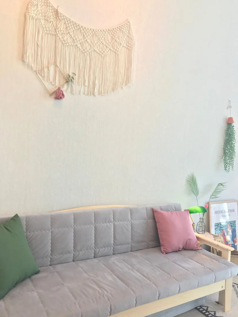 Sofa corner with a macrame wall hanging and cushions (Listing ID : 31163)