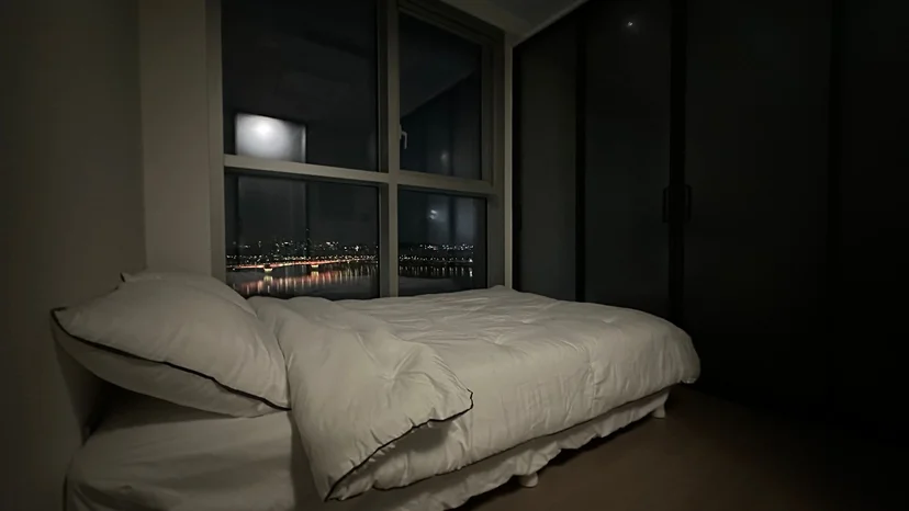 Bed set beside a large window with a night view of the Han River and city lights (Listing ID : 32655)