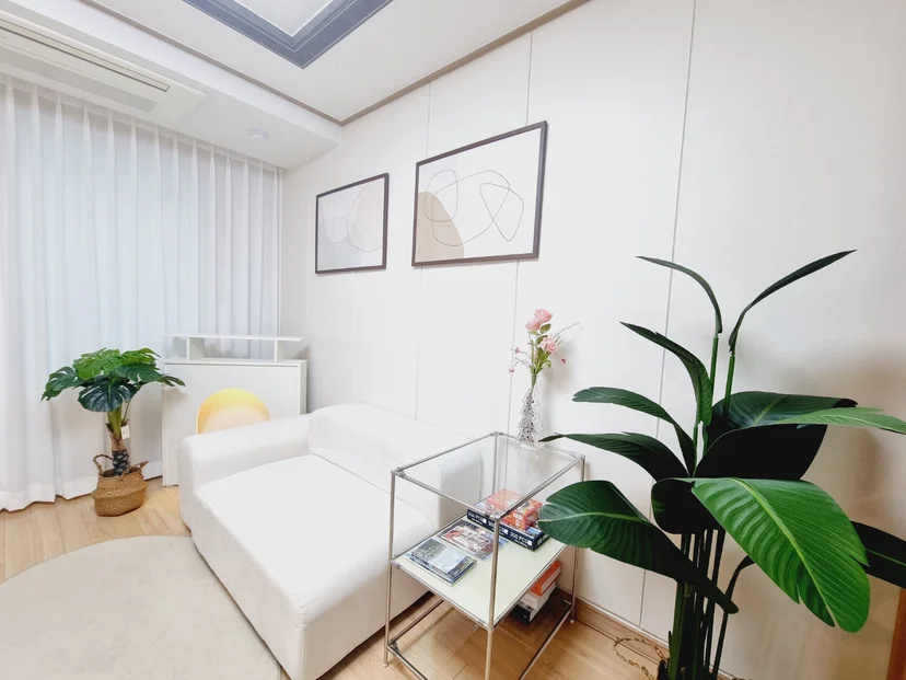 Bright lounge with a white sofa and indoor plants (Listing ID : 32182)