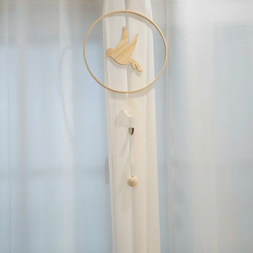 Wooden bird ornament hanging by the sheer window curtains (Listing ID : 25853)