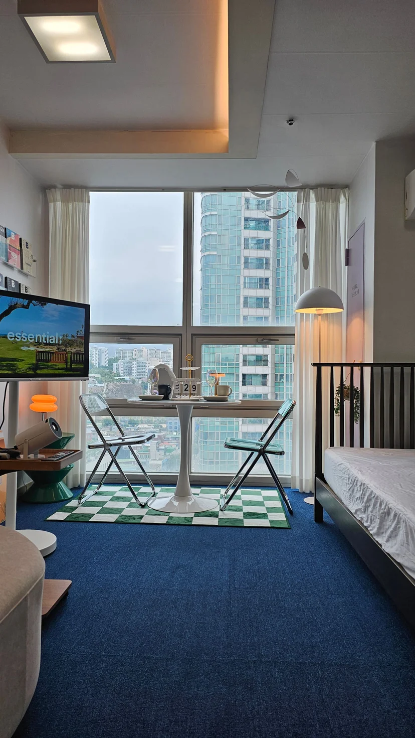 Studio with floor-to-ceiling city view, dining set, TV and bed corner (Listing ID : 28024)