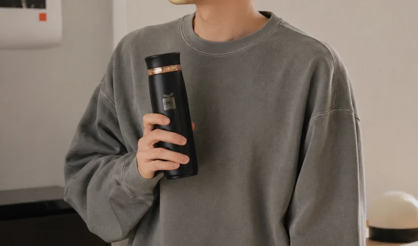 마플 락앤락 뉴 페더라이트 링 텀블러 브랜드 로고를 각인한 블랙 제품을 한 손으로 들고 있는 이미지