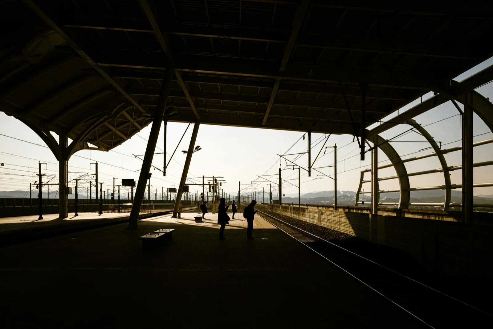Passengers waiting on a Korean train station platform, showing typical signage and platform layout