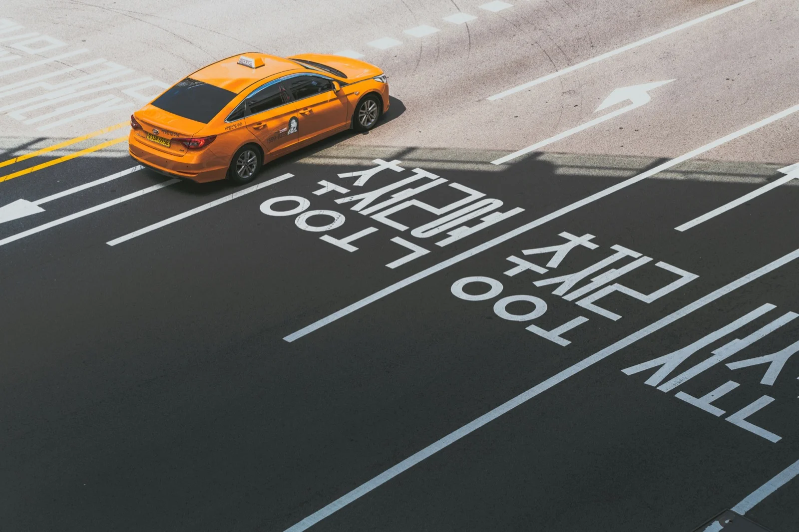 Orange taxi cab on a Seoul street, the type of taxi you can easily hail through the Kakao T app
